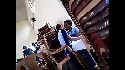 woman and stud kissing in school
