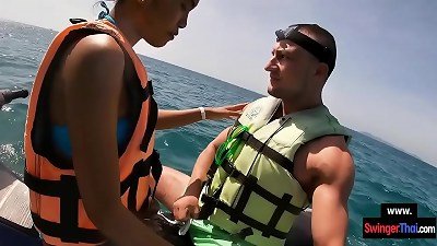Asian girlfriend gives a blowjob in public on a jetski