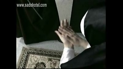 bend over nun is slapped on her arse and forearms with a wooden stick by priest
